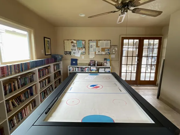 a living room with large window and furniture