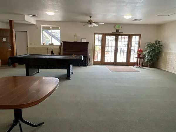 a living room with furniture a window and a chandelier
