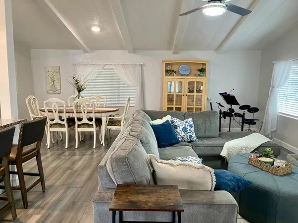 a living room with furniture dining table and a large window