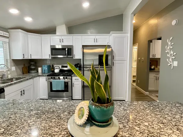 a kitchen with sink cabinets and appliances