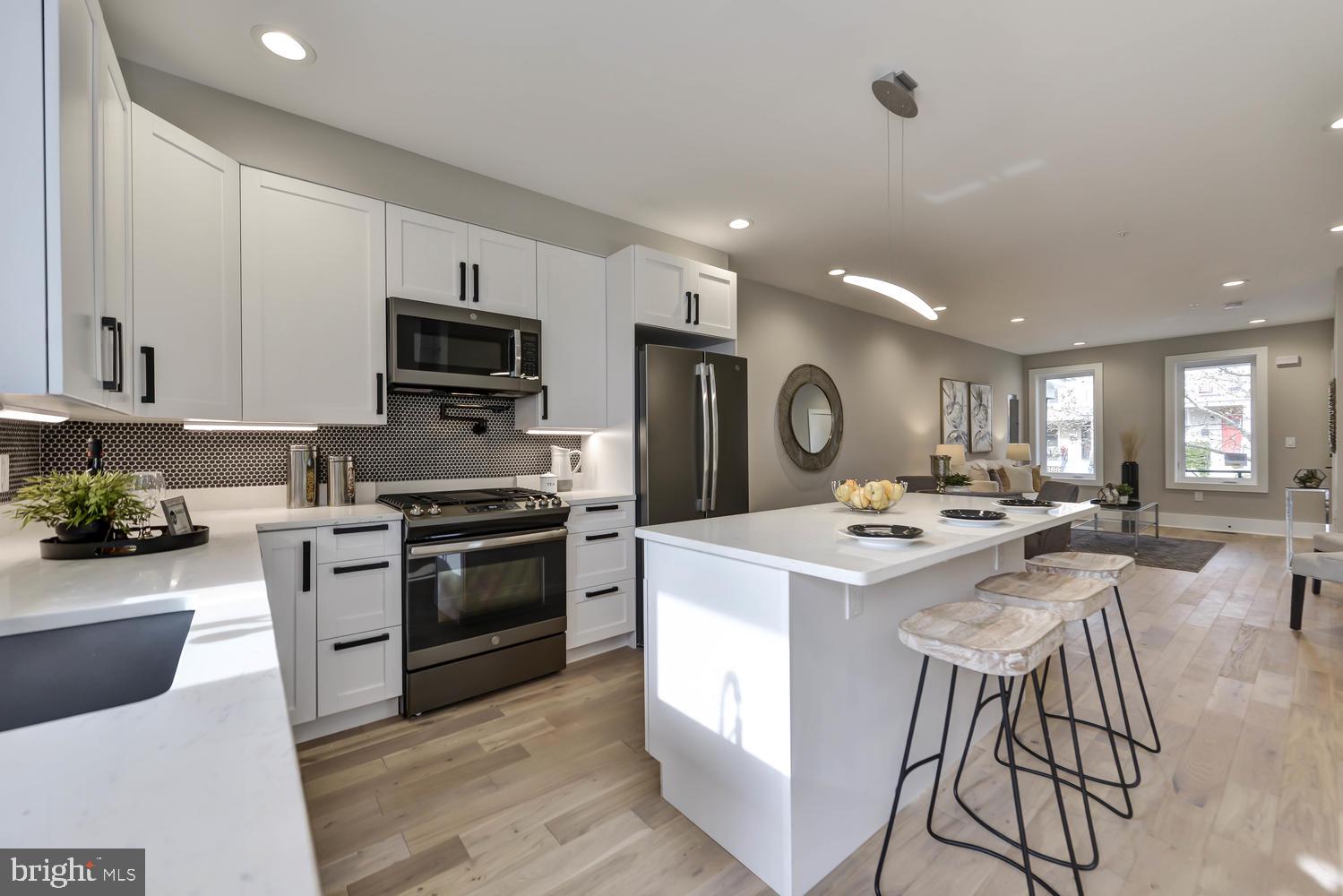 113 U Street Northeast, Unit A Washington, DC 20002 - Photo 9 of 32 Breakfast bar/island w/ quartz countertops