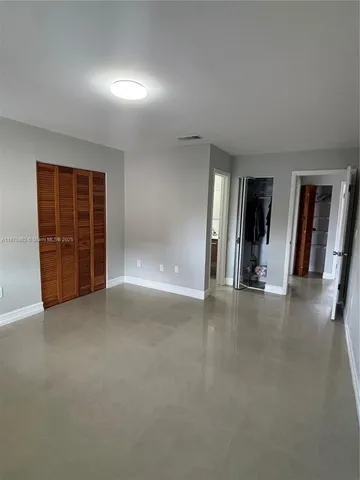 an empty room with a yard and closet