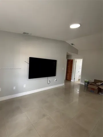 a view of a livingroom with furniture and a flat screen tv