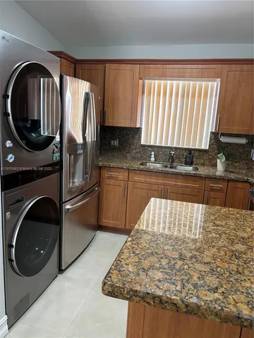a kitchen with a stove a sink and a microwave
