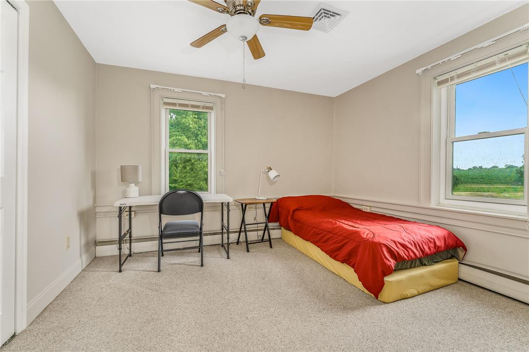 4831 Steuben Road Nazareth, PA 18064 - Photo 16 of 34 A restful chamber awaits, complete with a ceiling fan for comfort and sun-filled windows framing verdant views.