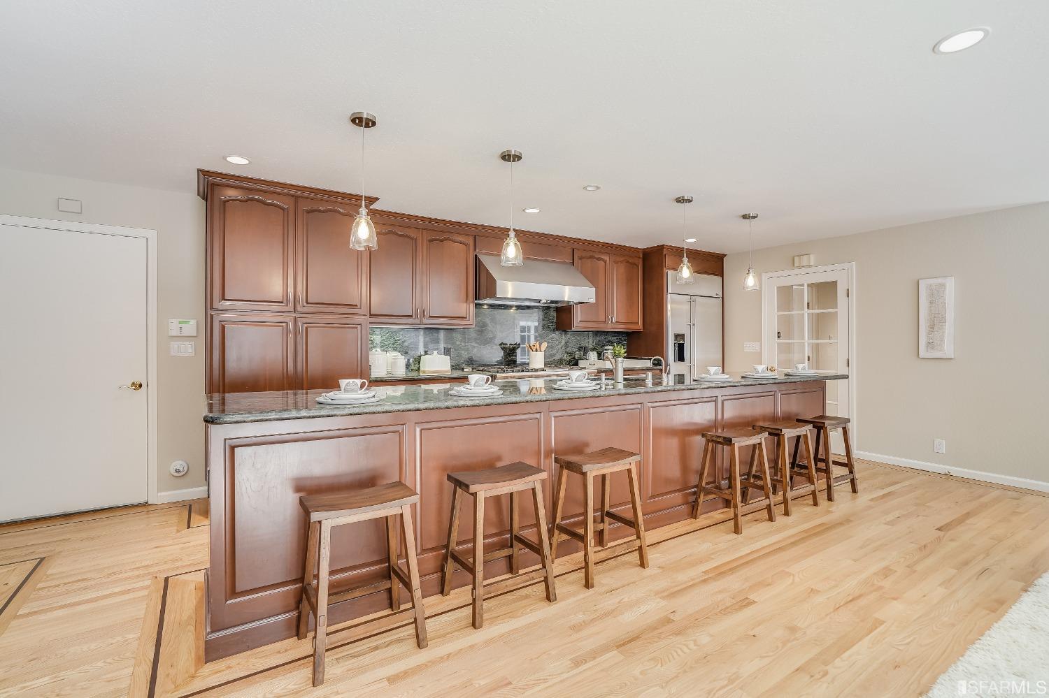 1838 Whitecliff Way San Mateo, CA 94402 - Photo 18 of 56 a kitchen with stainless steel appliances granite countertop a dining table chairs and granite counter tops