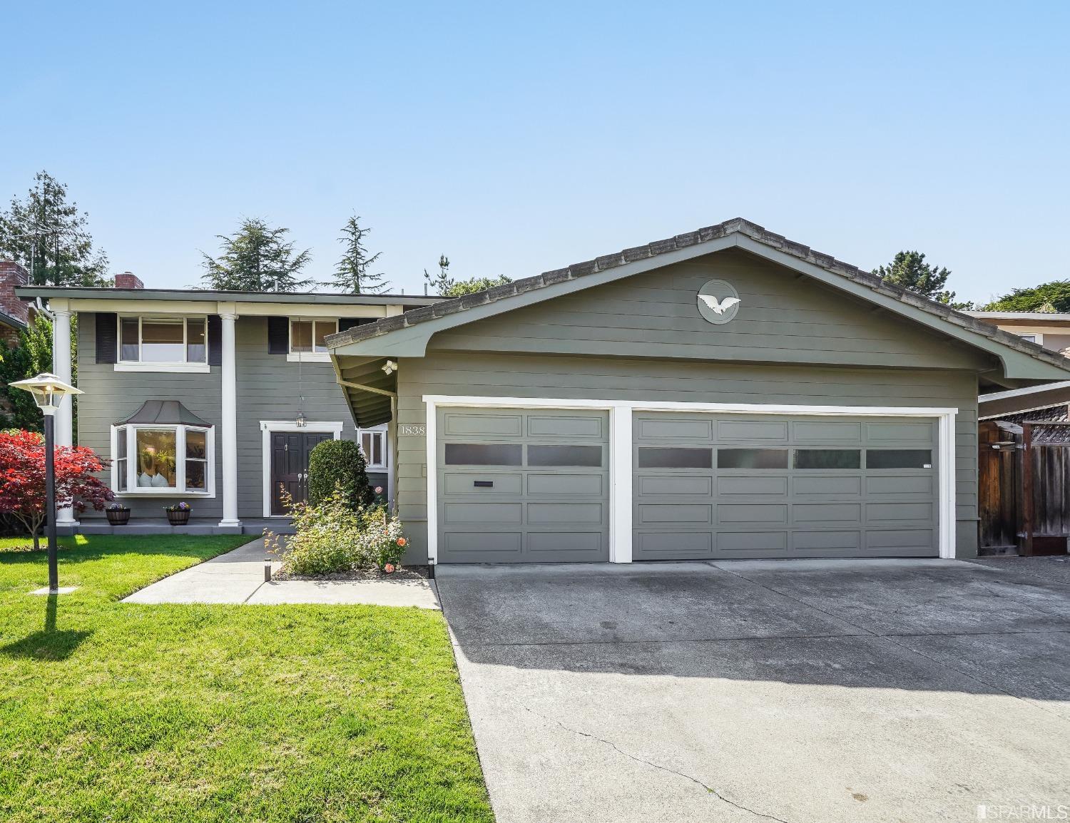 1838 Whitecliff Way San Mateo, CA 94402 - Photo 2 of 56 a front view of a house with a yard and garage
