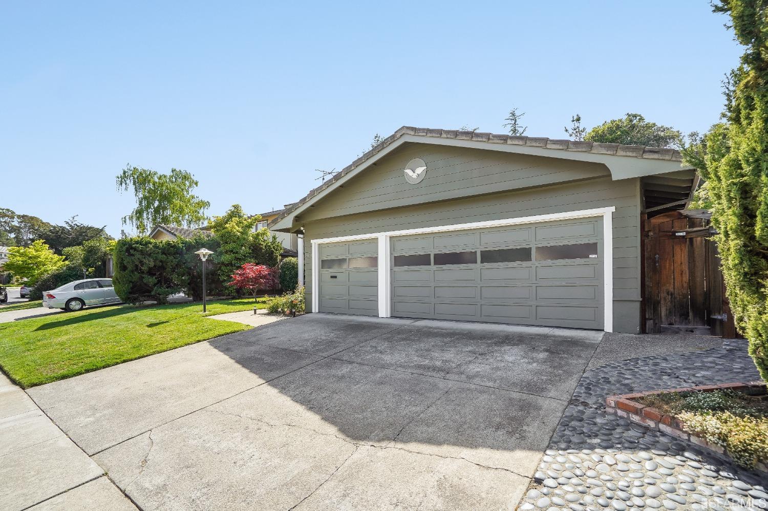 1838 Whitecliff Way San Mateo, CA 94402 - Photo 3 of 56 a front view of a house with a yard and garage