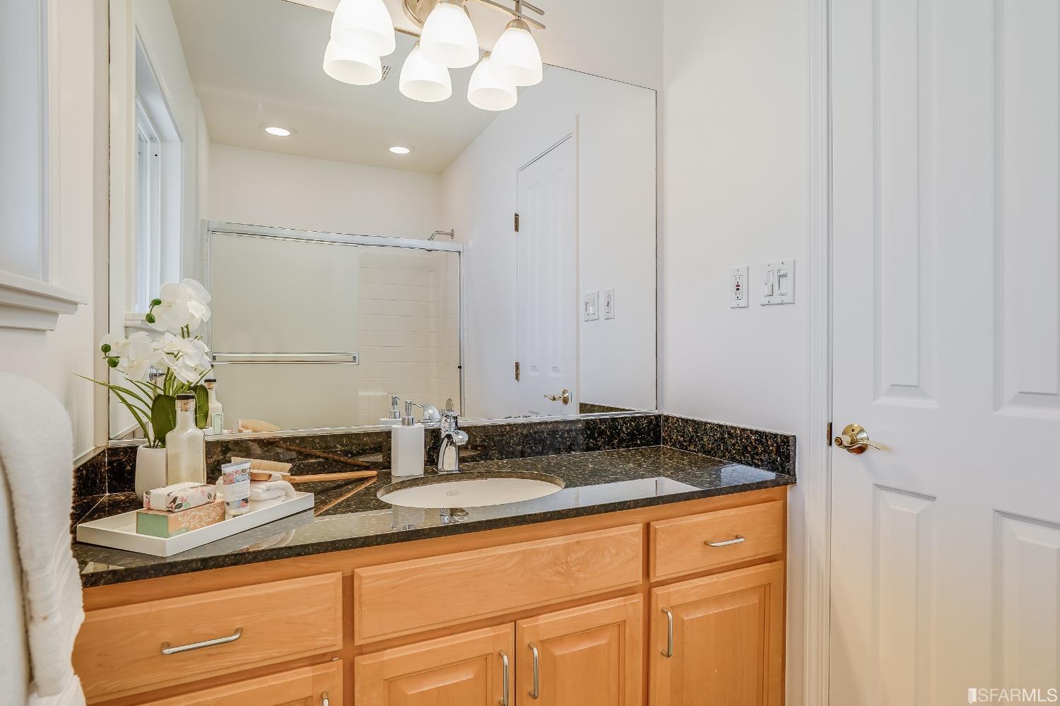 1838 Whitecliff Way San Mateo, CA 94402 - Photo 32 of 56 a bathroom with a granite countertop sink and a mirror