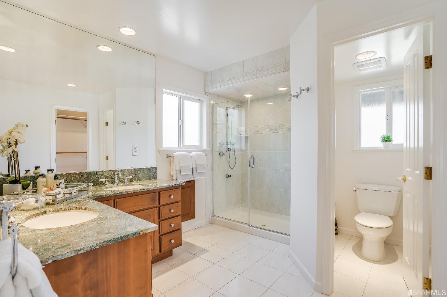 1838 Whitecliff Way San Mateo, CA 94402 - Photo 37 of 56 a bathroom with a granite countertop sink a toilet a mirror and shower