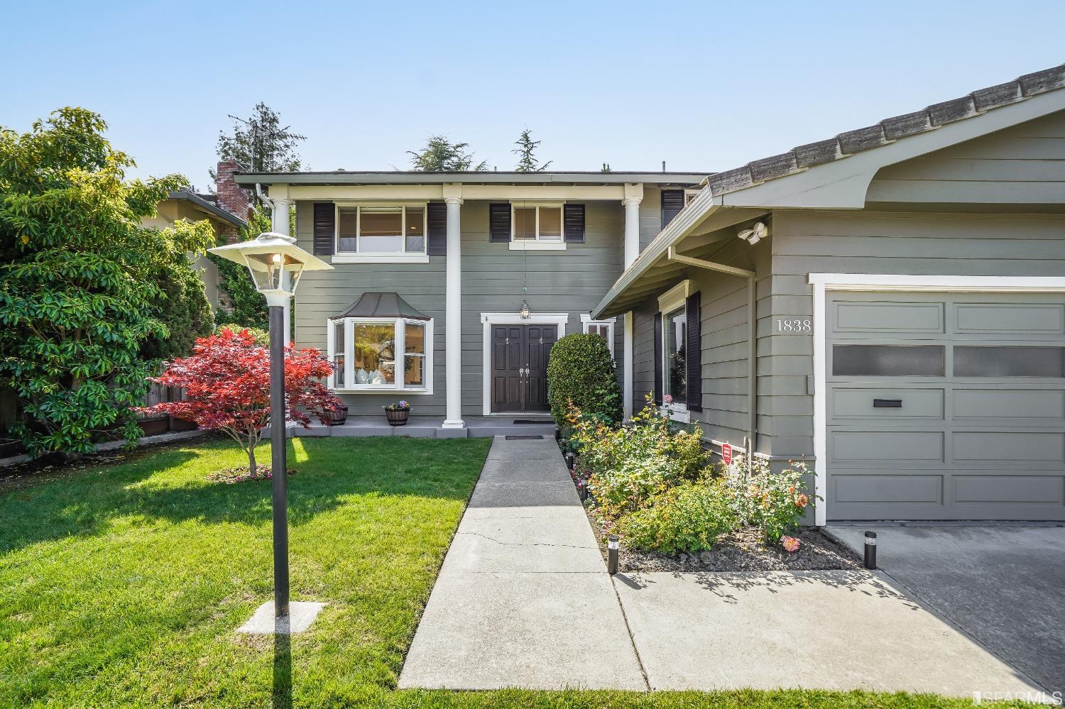 1838 Whitecliff Way San Mateo, CA 94402 - Photo 4 of 56 a front view of a house with a garden and plants