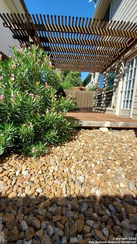 a view of a yard with wooden fence