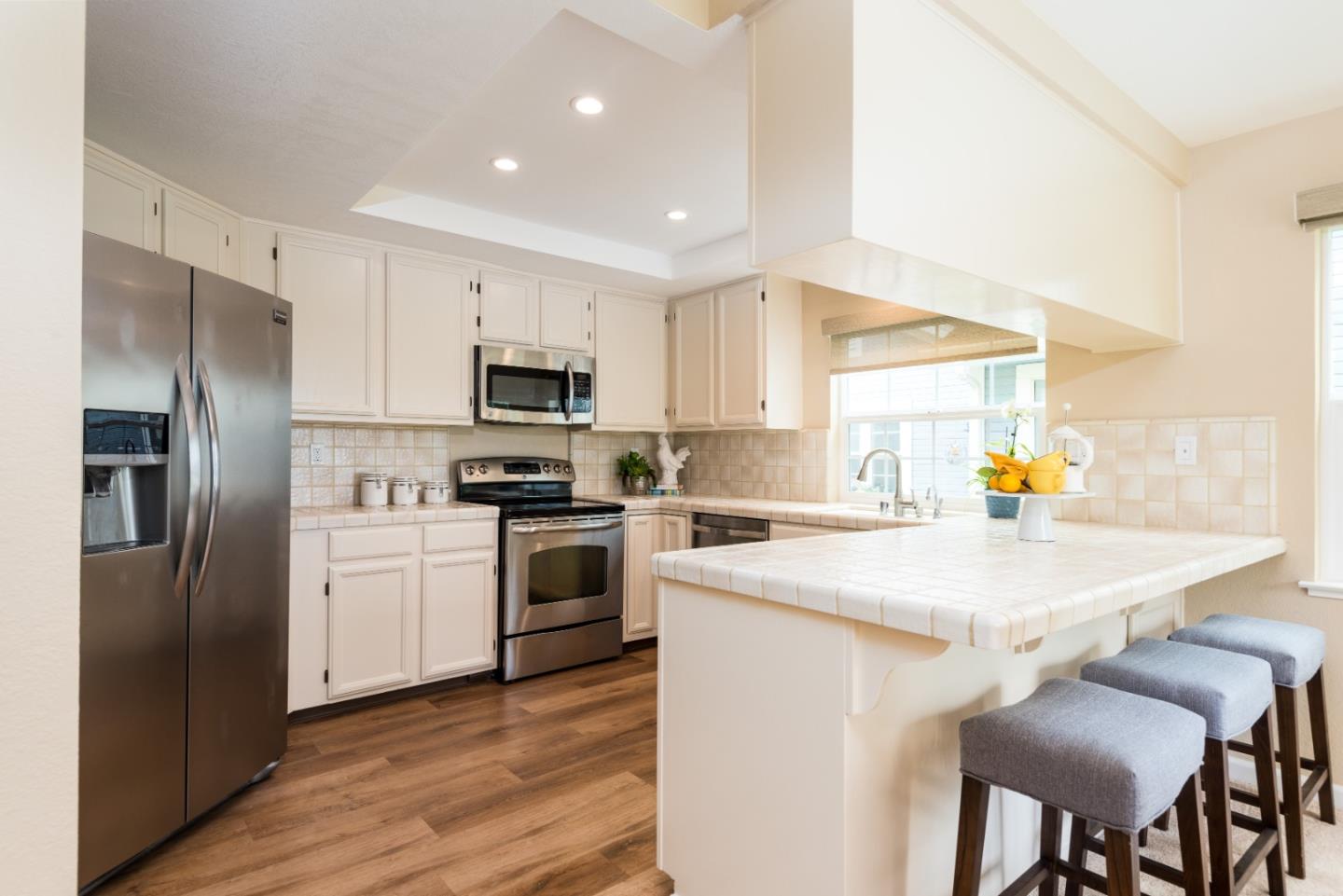 6 Muirfield Road Half Moon Bay, CA 94019 - Photo 7 of 25 a kitchen with a refrigerator a stove top oven a sink and dishwasher