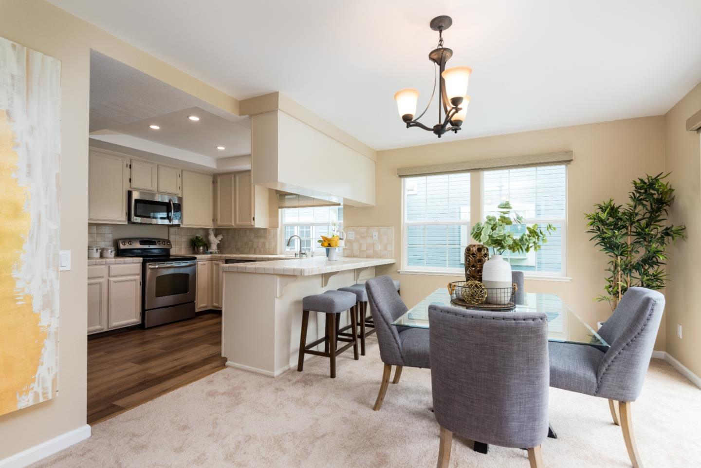 6 Muirfield Road Half Moon Bay, CA 94019 - Photo 8 of 25 a kitchen with a refrigerator and a table chair
