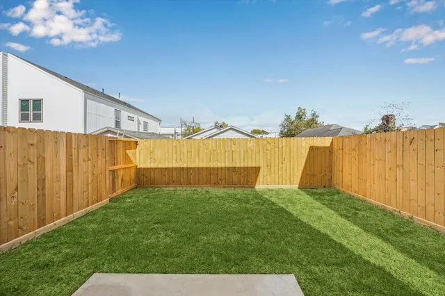 a view of a house with backyard and a garden