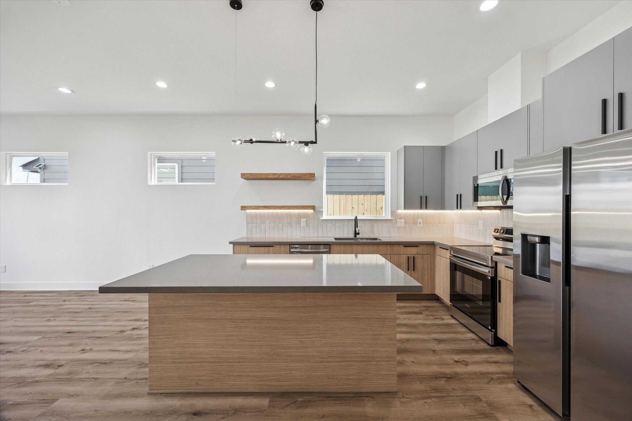 3719 Lydia Street, Unit B Houston, TX 77021 - Photo 4 of 20 a large kitchen with kitchen island a large counter top stainless steel appliances and cabinets