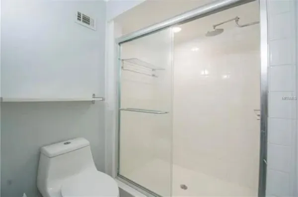 a bathroom with a toilet and shower