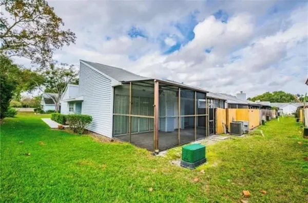 a backyard of a house with table and chairs