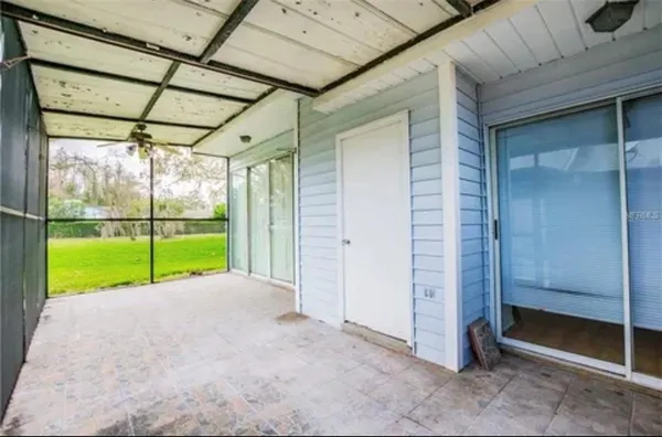 a view of a room with wooden floor and sliding door