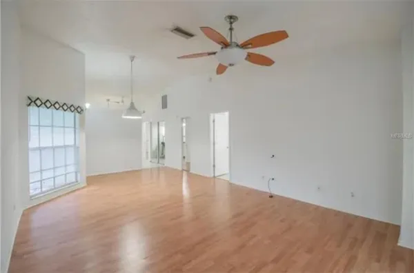 an empty room with closet and windows