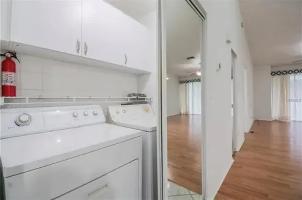 a view of washer and dryer with kitchen in the background