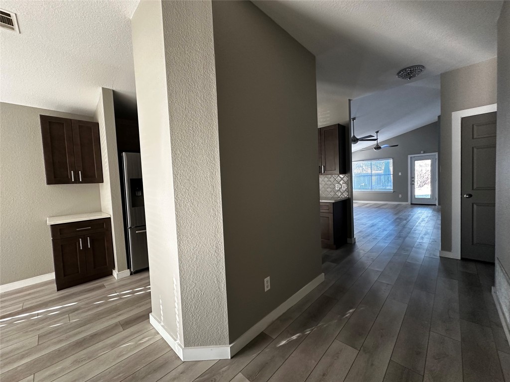17733 Loch Linnhe Loop Pflugerville, TX 78660 - Photo 2 of 16 a view of a hallway view with wooden floor and seating space