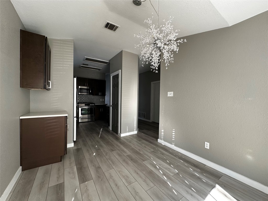 17733 Loch Linnhe Loop Pflugerville, TX 78660 - Photo 4 of 16 a view of a livingroom with a chandelier