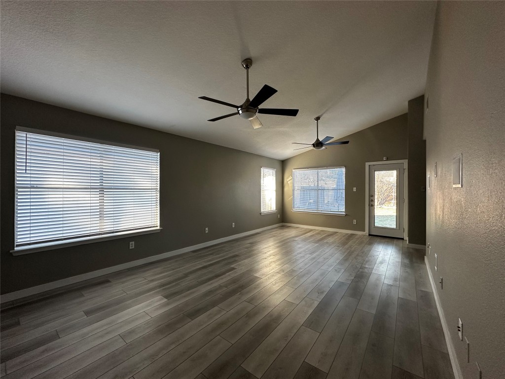 17733 Loch Linnhe Loop Pflugerville, TX 78660 - Photo 8 of 16 a view of an empty room with a window and wooden floor