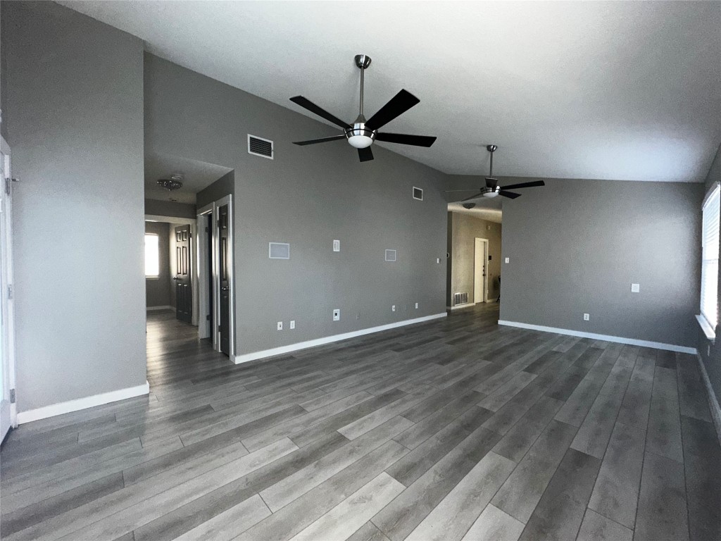 17733 Loch Linnhe Loop Pflugerville, TX 78660 - Photo 9 of 16 an empty room with wooden floor and a ceiling fan