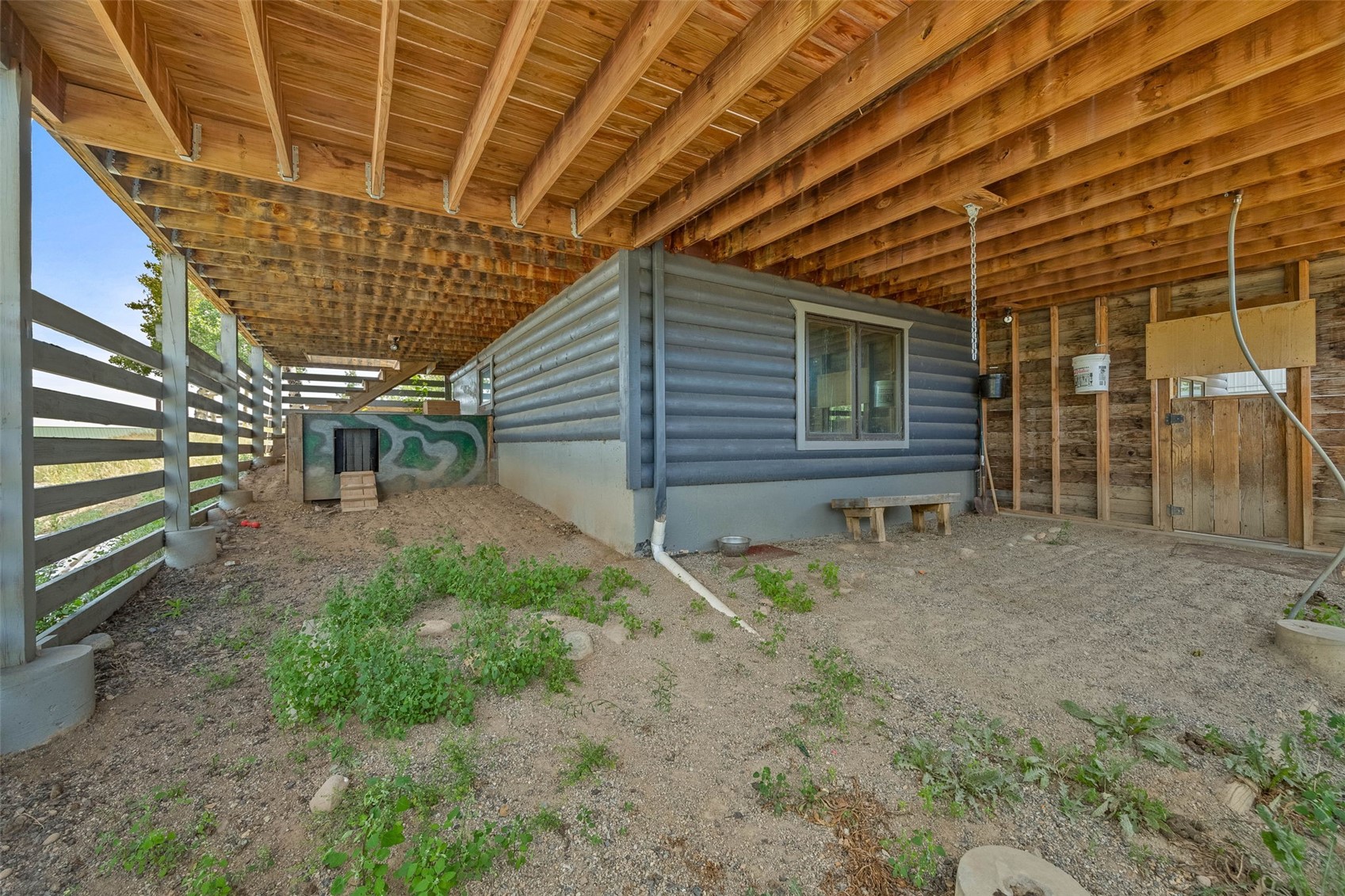 597 Sheep Ridge Road Fairplay, CO 80440 - Photo 29 of 50 a backyard of a house with large trees and stairs