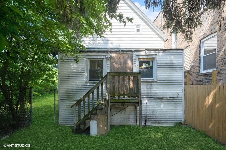 5943 South Aberdeen Street Chicago, IL 60621 - Photo 5 of 8 a view of a house with a yard