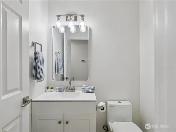 a bathroom with a toilet sink and mirror