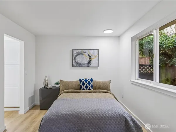a bedroom with furniture and a window