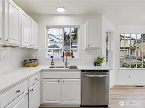 a kitchen with a sink cabinets and window
