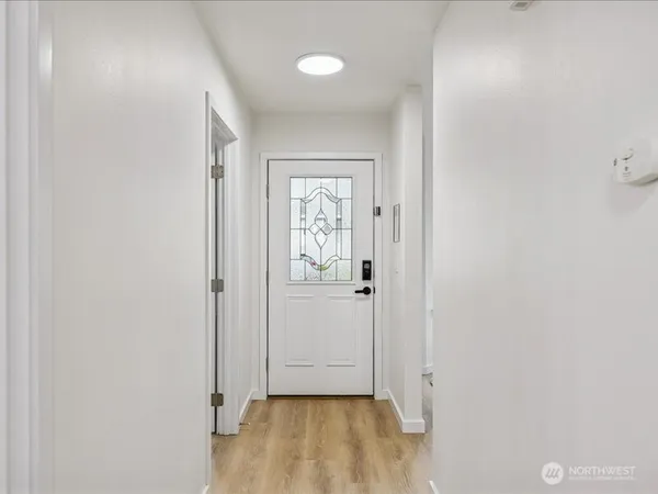 a view of a hallway with wooden floor