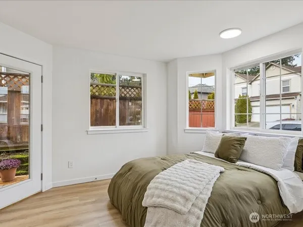 a bedroom with a bed and a window