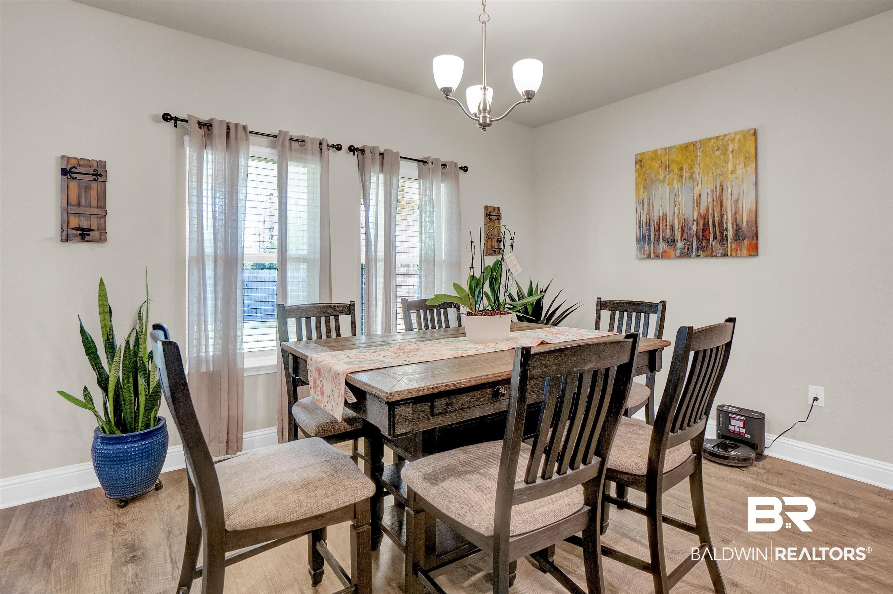 31671 Memphis Loop Daphne, AL 36527 - Photo 24 of 51 Dining room featuring light wood-style flooring, a notable chandelier, and baseboards