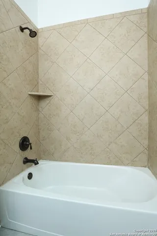 a bathroom with a shower and a bathtub