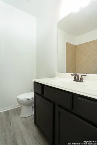 a bathroom with a sink a toilet and mirror