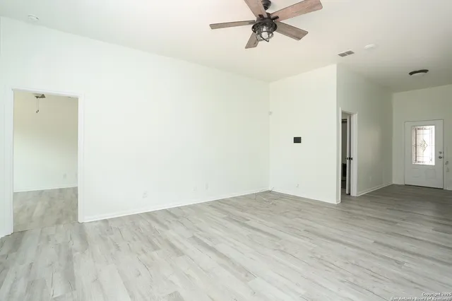a view of a room with wooden floor and closet area