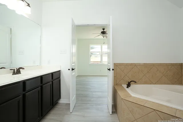 a bathroom with a bathtub and a sink
