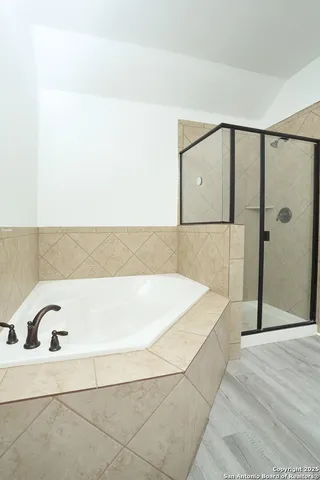a bathroom with a bathtub and shower