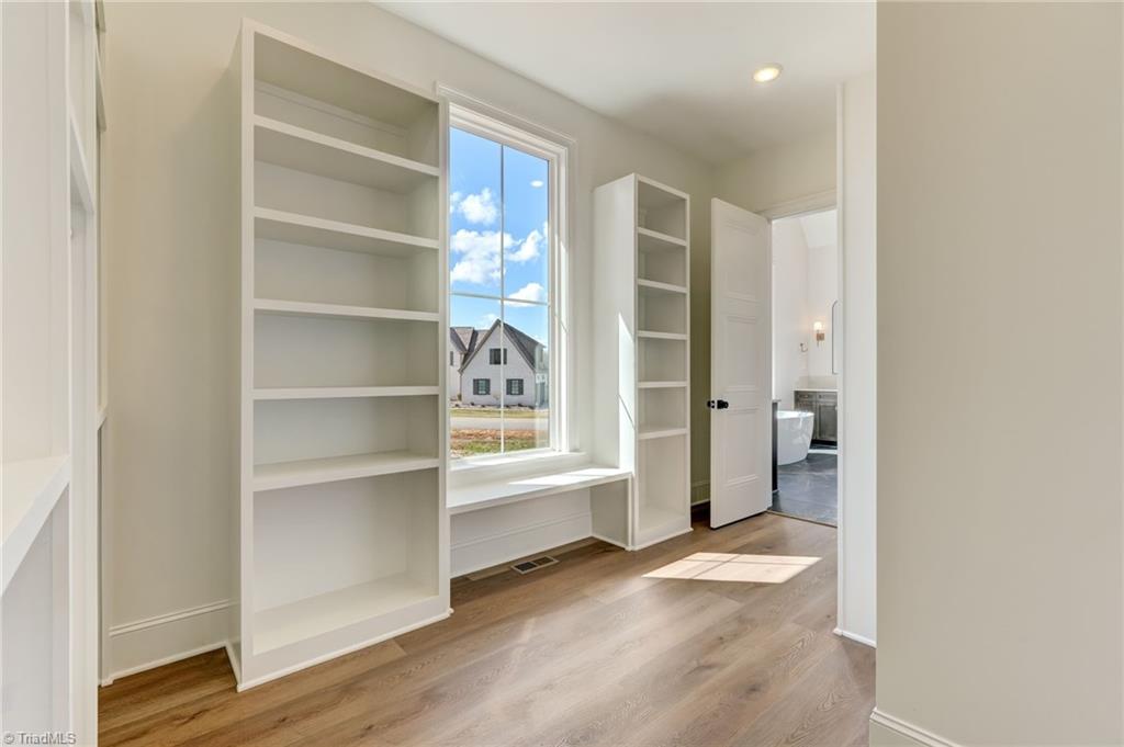 7688 Kyran Court Oak Ridge, NC 27310 - Photo 19 of 40 Primary walk-in closet is a dream with a custom closet organization system