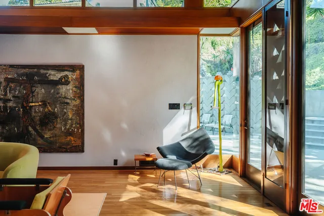 a living room with furniture and a floor to ceiling window