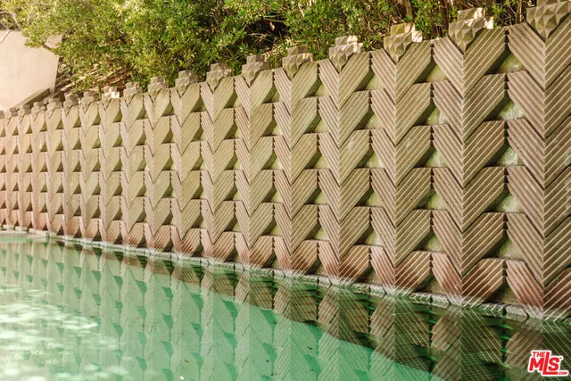 a view of a yard with plants and trees