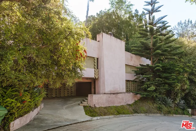 a view of a house with pool and sitting area