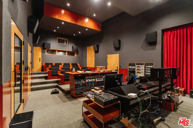 a yellow building with trees in front of it