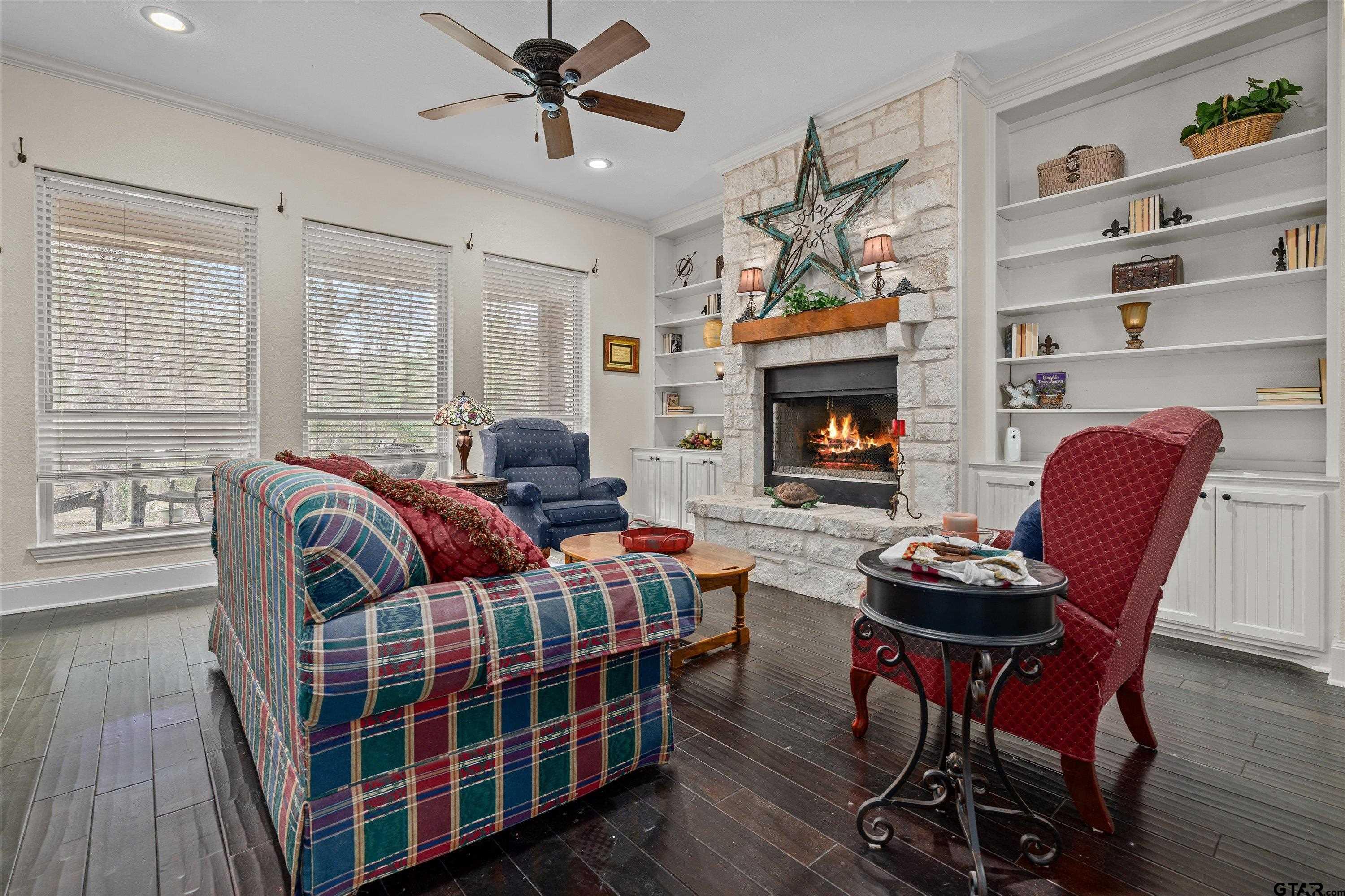 12170 Copper Court Tyler, TX 75706 - Photo 12 of 35 a living room with furniture a fireplace and wooden floor
