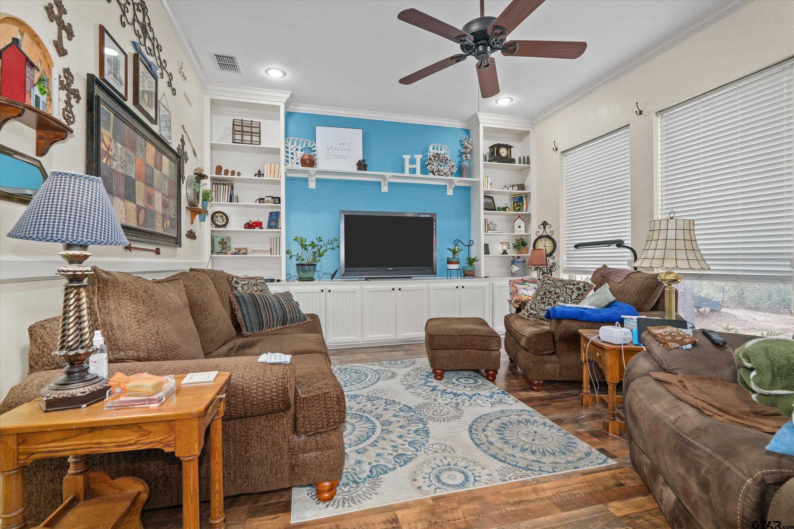 12170 Copper Court Tyler, TX 75706 - Photo 17 of 35 a living room with furniture a flat screen tv and a dining table