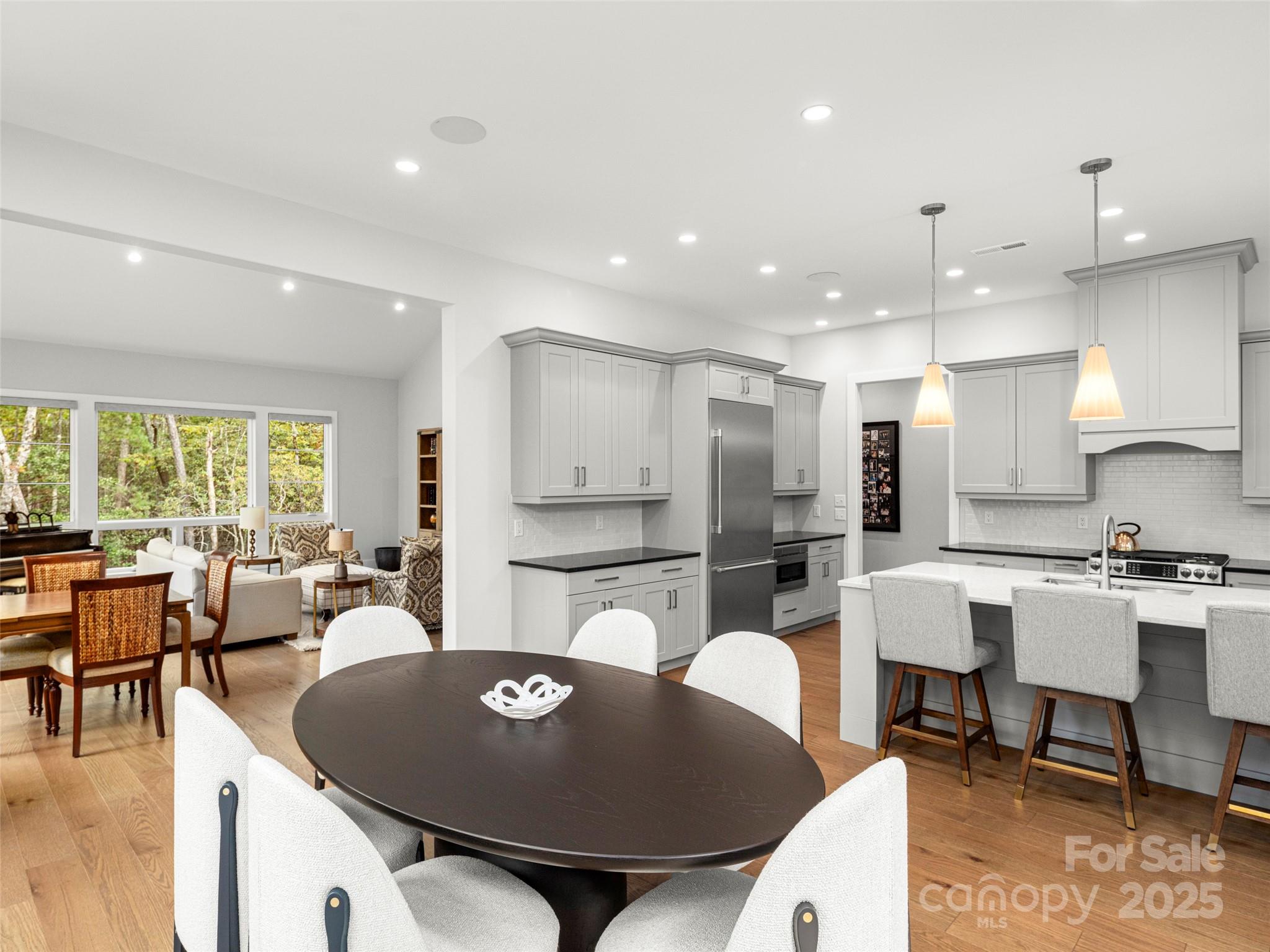 1565 Country View Way Arden, NC 28704 - Photo 13 of 31 a living room with stainless steel appliances furniture a dining table and chairs